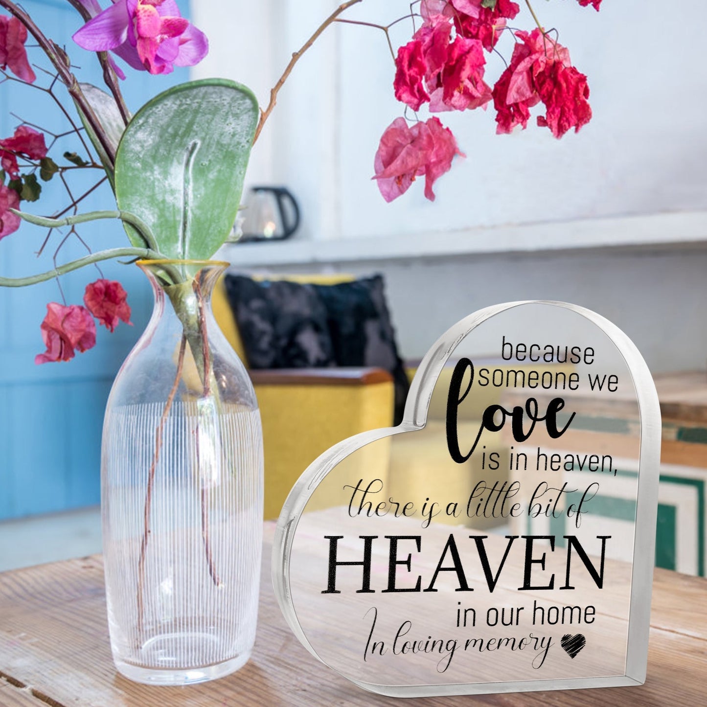 Acrylic memorial heart ornament from The Wind Chime Co with engraved "Heaven In Our Home" message, displayed on a stand.