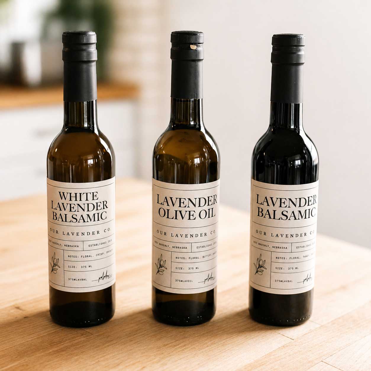 Lavender Balsamic Vinegar from Our Lavender Co, 12.7 oz bottle, with a dark vinegar liquid and lavender sprigs on the label.