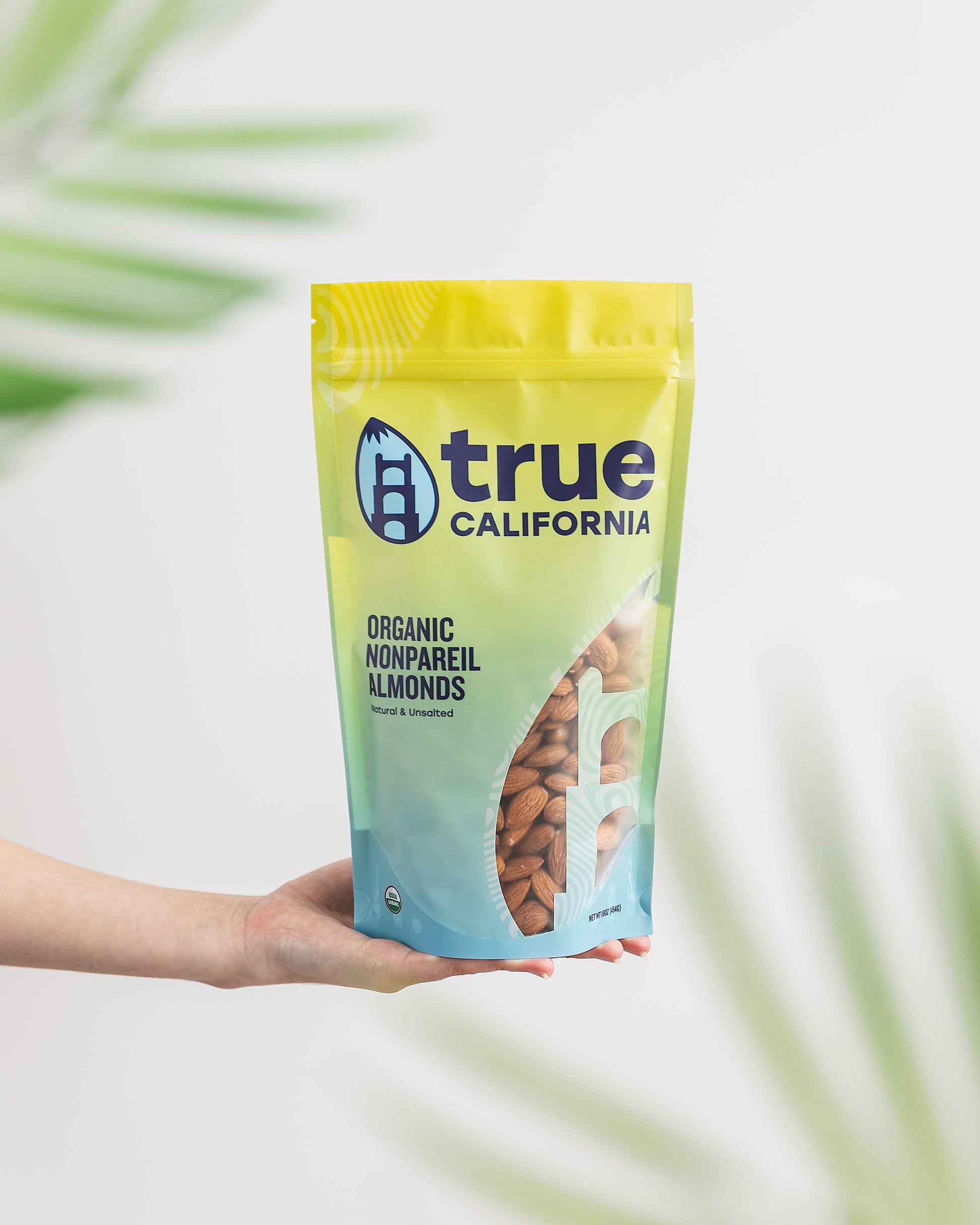 True California Organic Nonpareil Almonds in a 1 lb bag, showing fresh, whole almonds with smooth, light-colored shells.