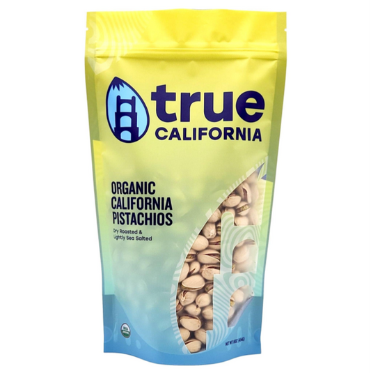Close-up of True California organic pistachios, dry roasted and lightly sea salted in a 1 lb package.