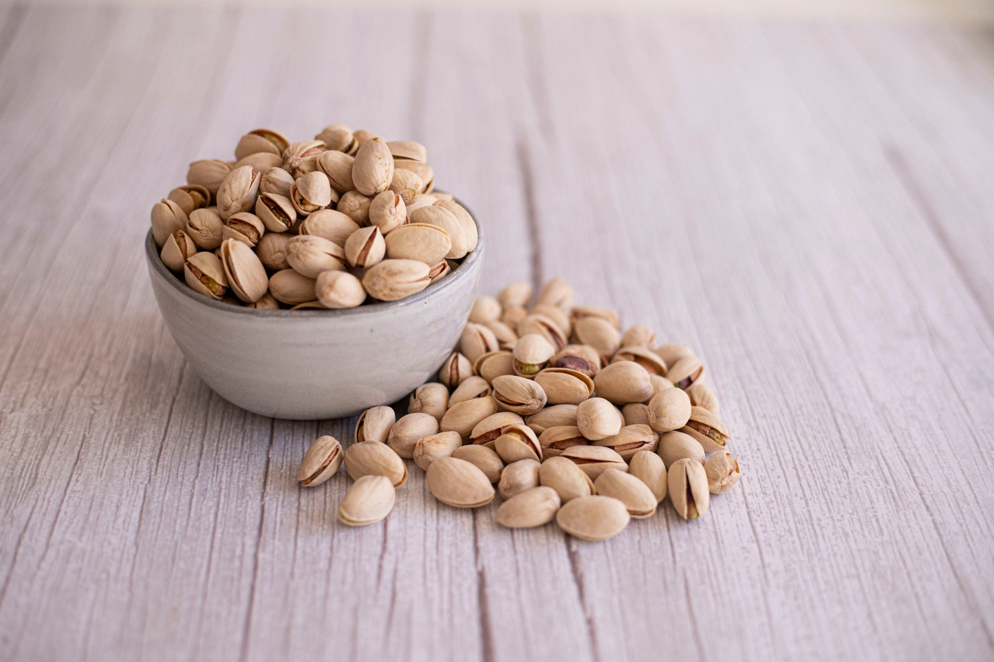 Organic pistachios from True California in a 1 lb bag, dry roasted and lightly salted, with open shells revealing green nuts inside.
