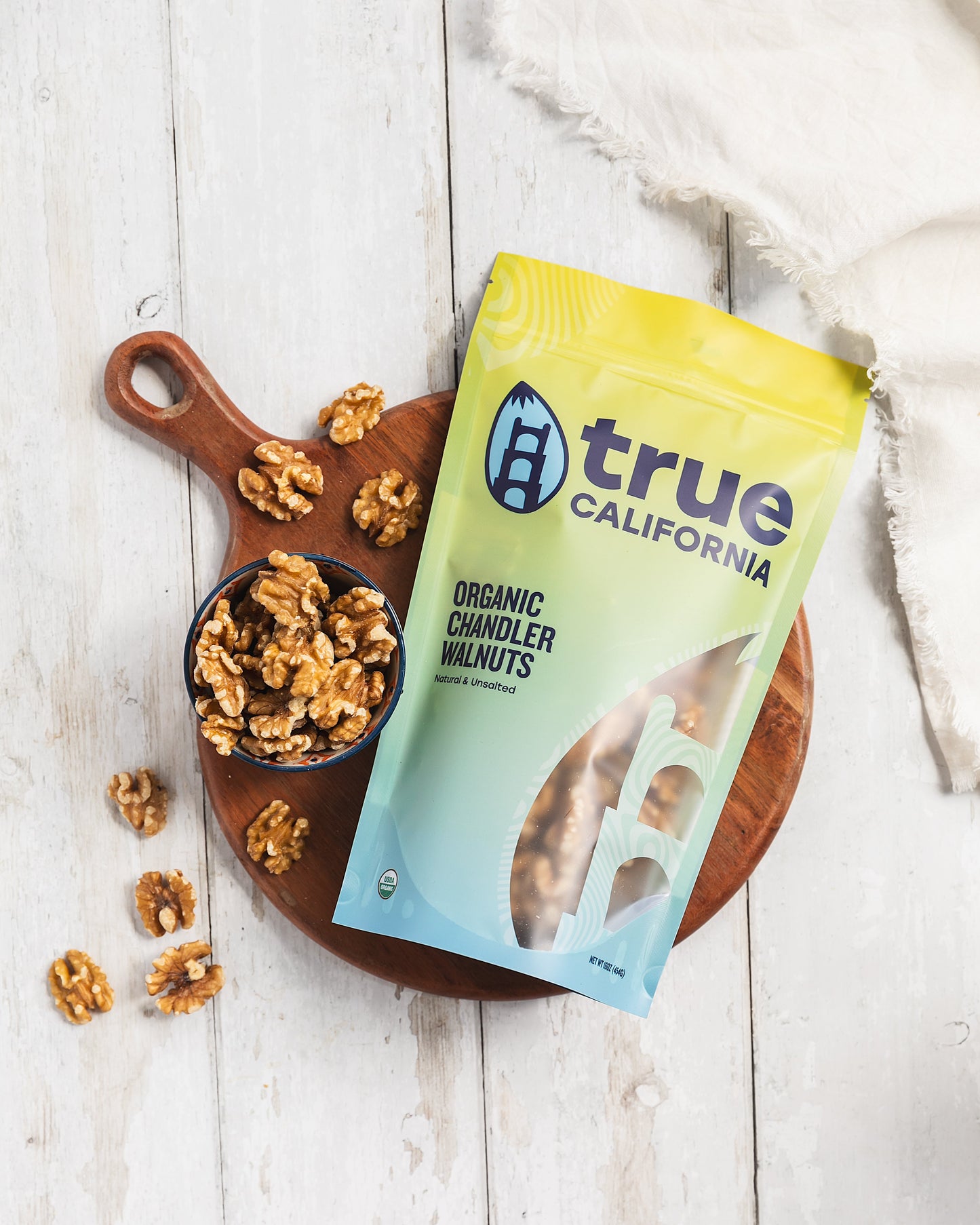 Organic Chandler walnuts from True California, whole walnuts in a 1 lb bag, showcasing their natural, rich brown shells.