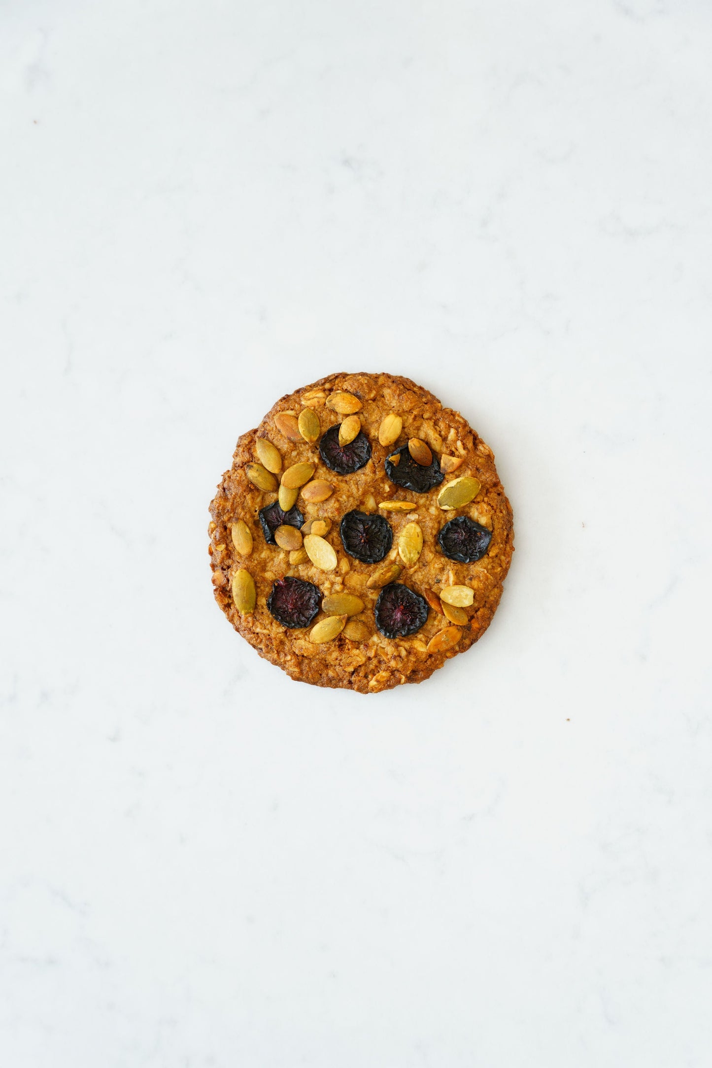 Three gluten-free vegan oat-cherry cookies from Heaven Gluten Free Bakery displayed on a plate.