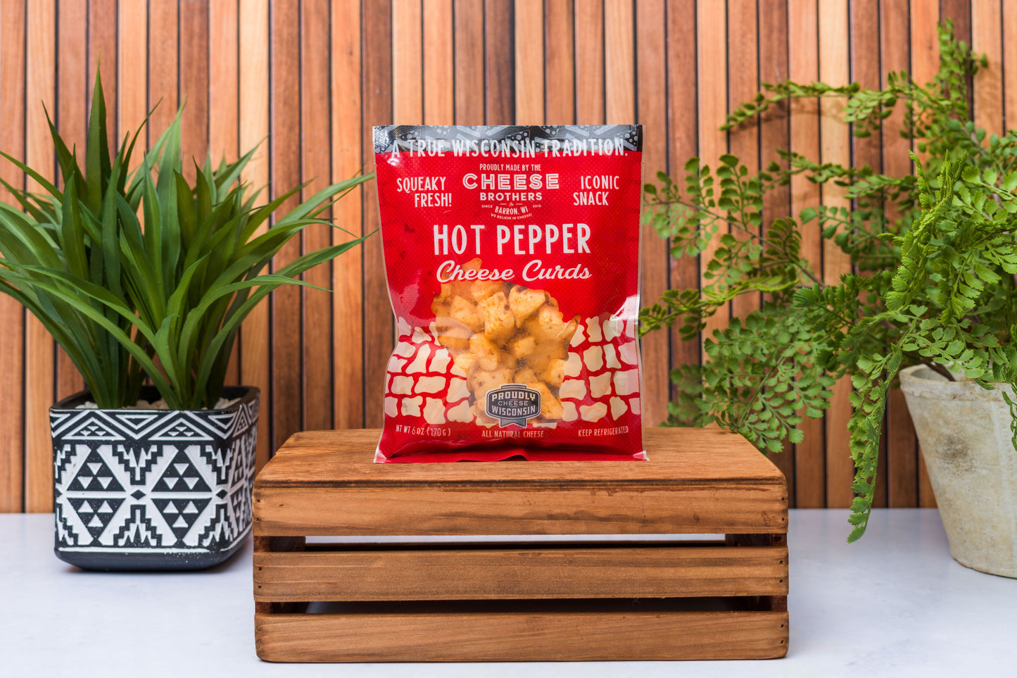 Wisconsin Cheese Brothers cheese curds sampler with 8 fresh, golden cheese curds in a gift bundle, ready for snacking.