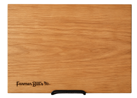 Cherrywood cutting board by Farmer Bill's Provisions, made in the USA, showing a sturdy, smooth surface with natural wood grain details.