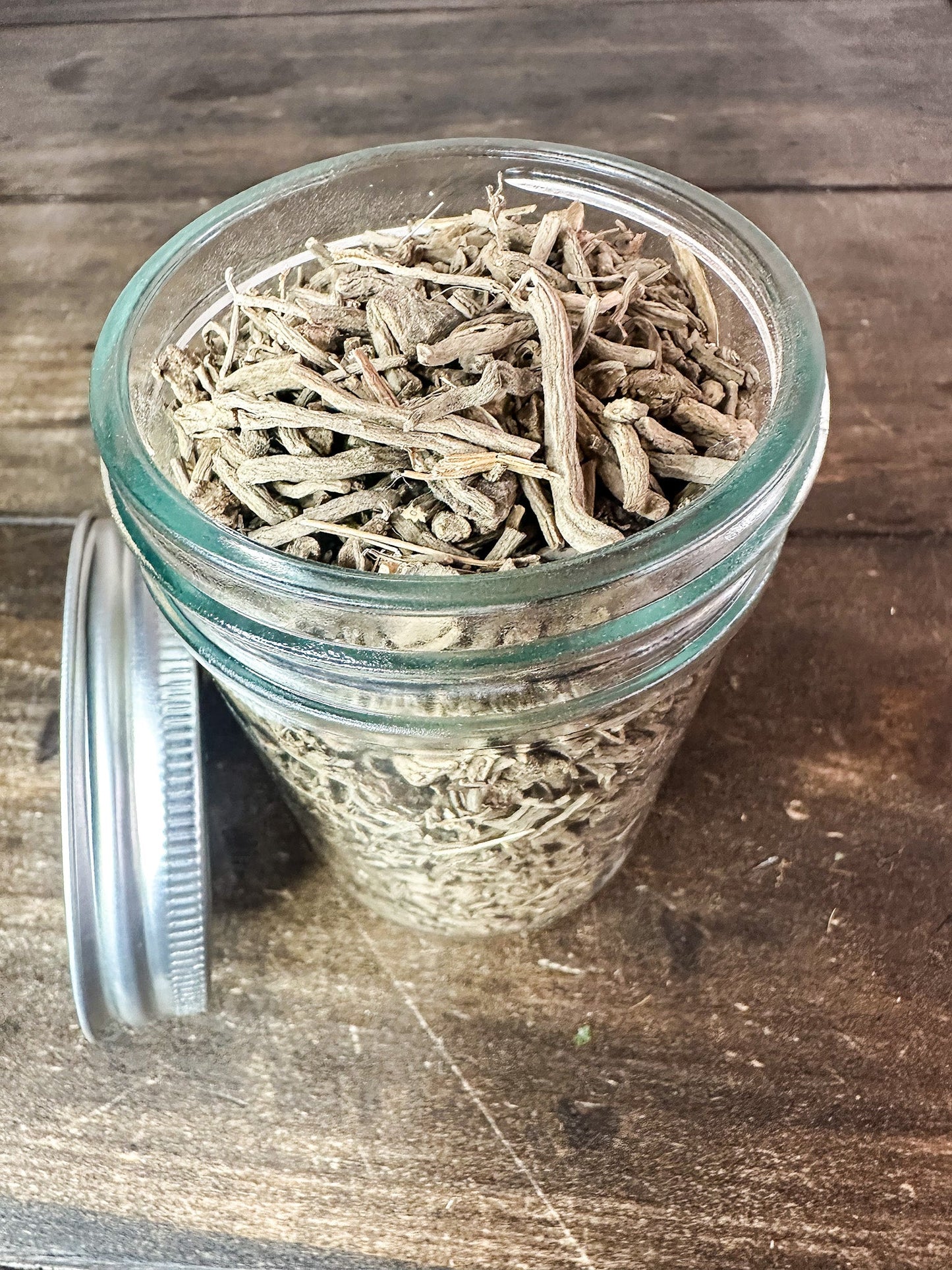 Small jar of dried valerian root herbs in a herbalroseapothecary herb jar, showcasing natural dried herb contents.