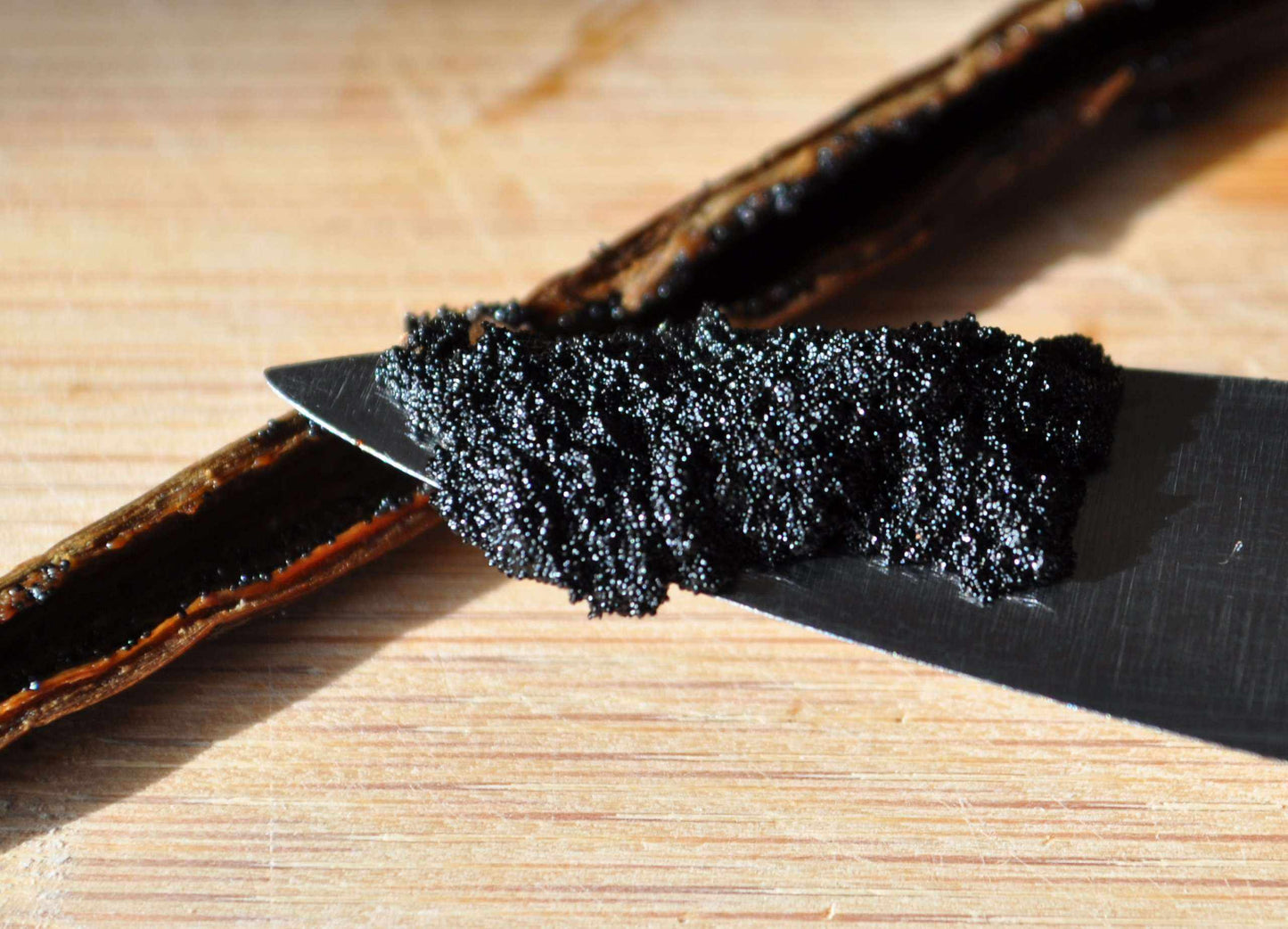 Homemade vanilla extract kit featuring organic Madagascar vanilla beans and a vanilla bean scraper from Vanilla Bean Kings.