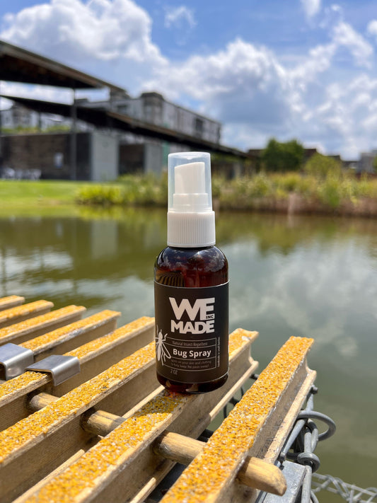 2 oz. bottle of WE Made bug spray with a spray nozzle, designed to repel insects effectively.