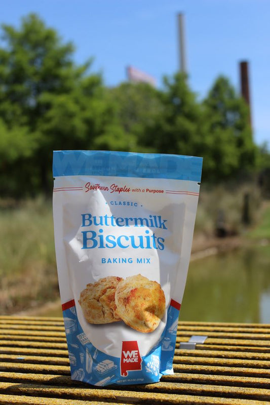 Buttermilk biscuit mix by WE Made, showing a bag of baking mix with a rustic kitchen background