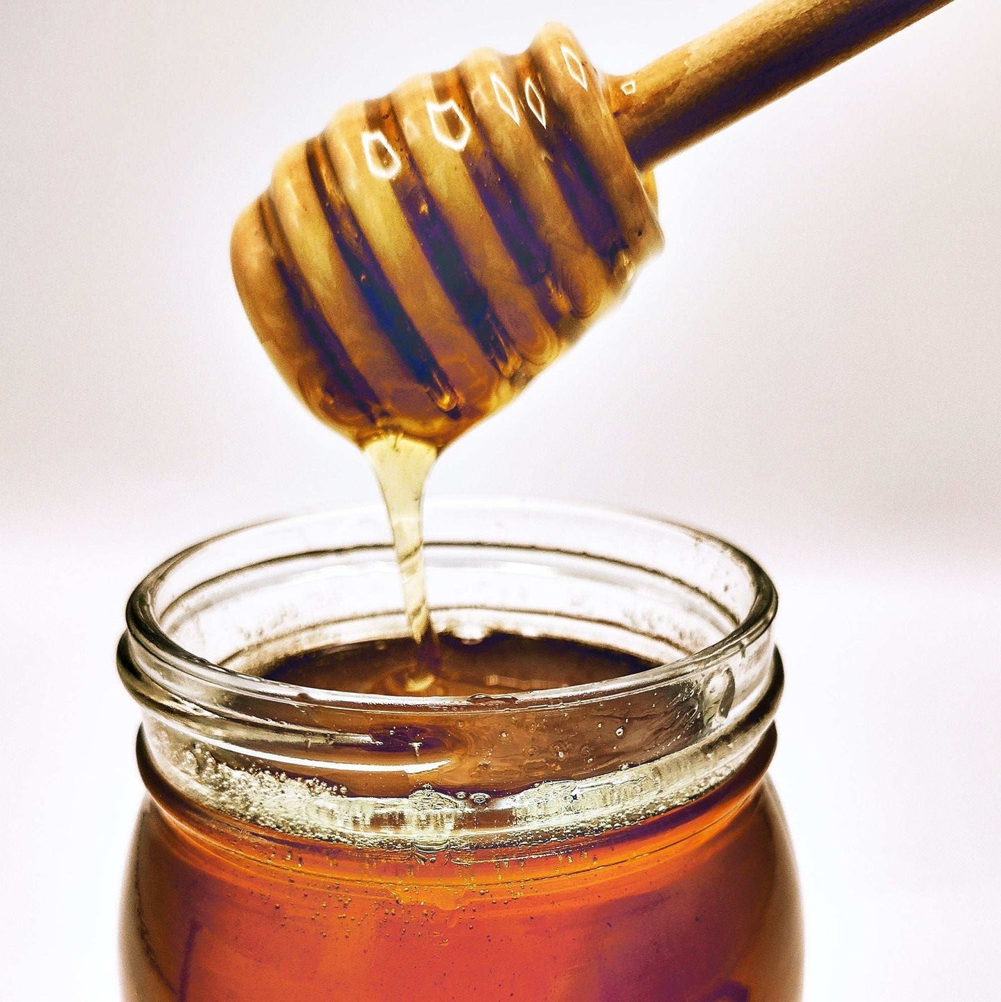 Weeks Raw Gold Reserve Honey from Georgia in a 16-ounce jar, unfiltered, natural honey with a golden color, produced by Weeks Honey Farm.