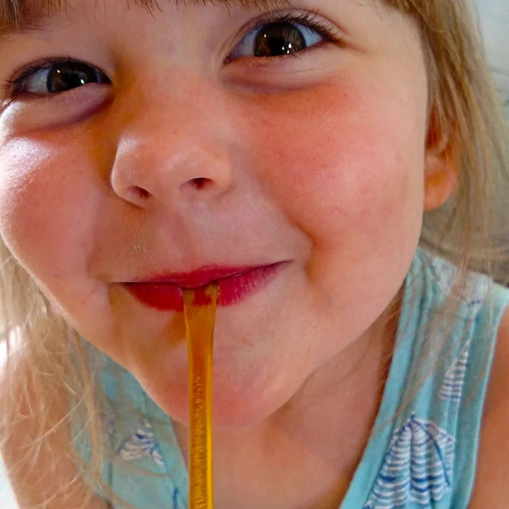 Raw honey straw from Weeks Honey Farm featuring orange blossom, wildflower, and raspberry honey in a convenient straw package.
