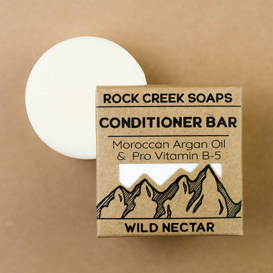 Wild Nectar Conditioner Bar with Argan Oil by Rock Creek Soaps, showing the natural, eco-friendly conditioner bar on a wooden surface.