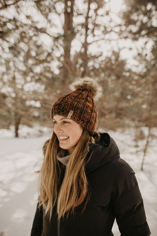 Brown multi-color Merino Wool Ribbed Knit Hat with faux fur pom-pom from Woolly Bear Knits, featuring a cozy, textured design.