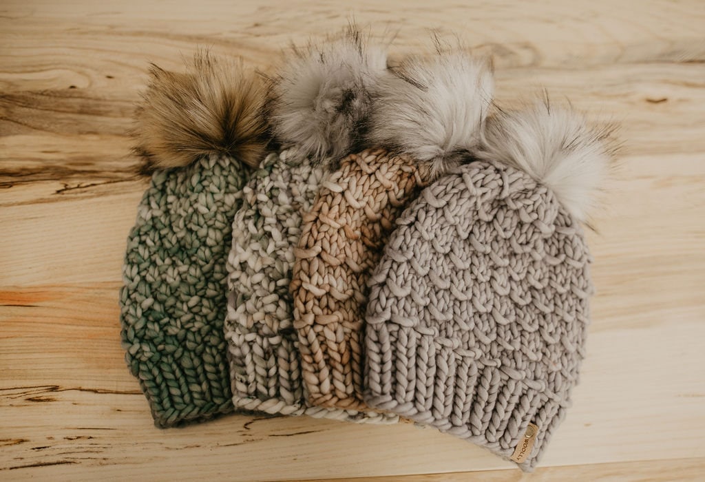 Pearl gray merino wool knit hat with faux fur pom pom by Woolly Bear Knits, cozy winter accessory with soft texture and stylish design.