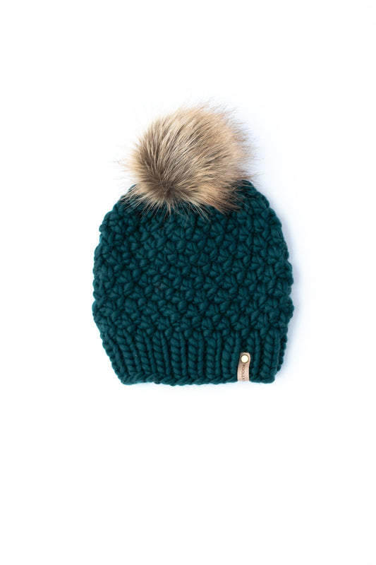 Forest green Peruvian wool knit hat with faux fur pom-pom by Woolly Bear Knits, showcasing cozy winter headwear.