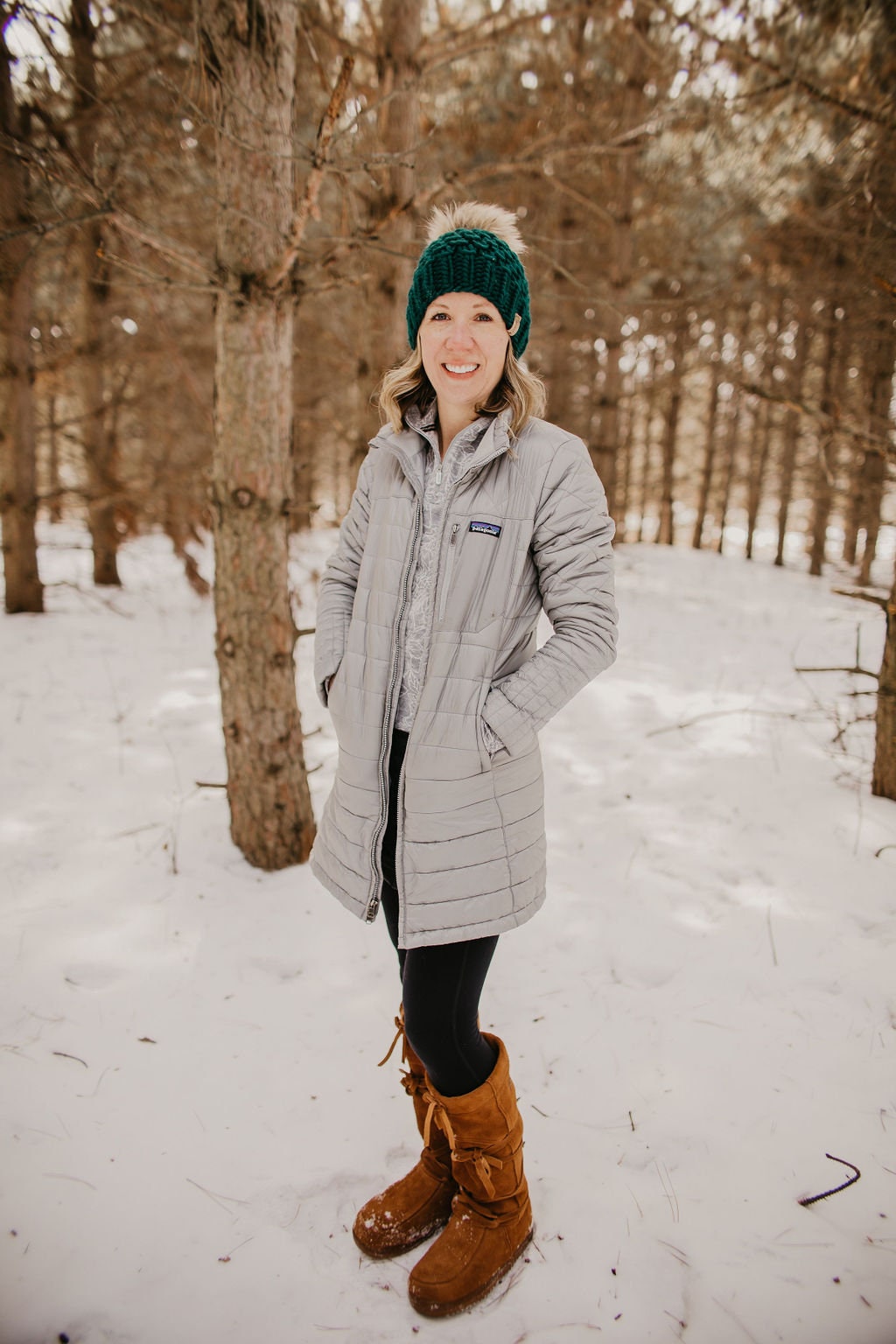 Forest green Peruvian wool knit hat with faux fur pom-pom by Woolly Bear Knits, showcasing cozy winter headwear with textured knit pattern.