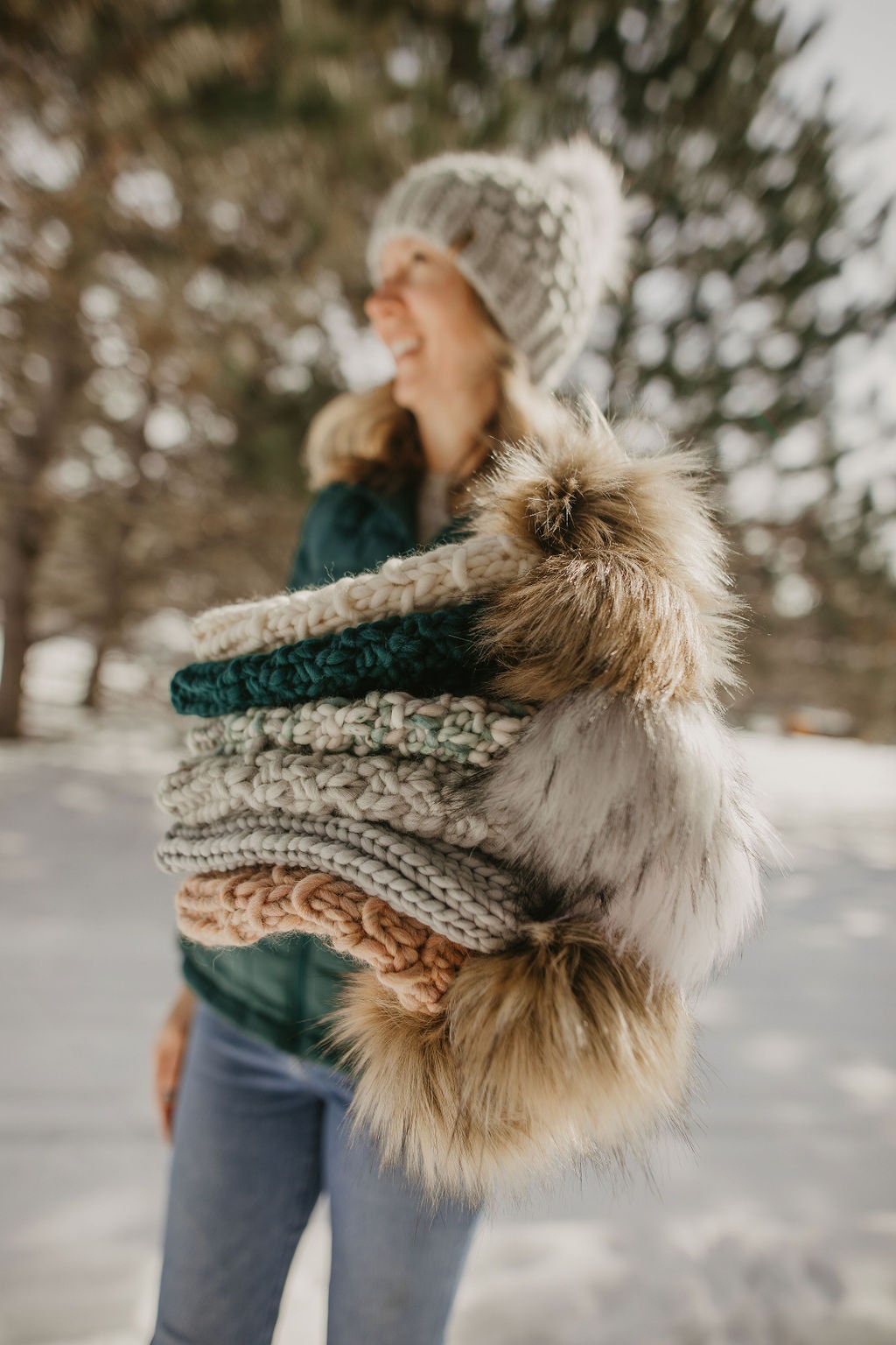 Forest green Peruvian wool knit hat by Woolly Bear Knits with a faux fur pom-pom on top.