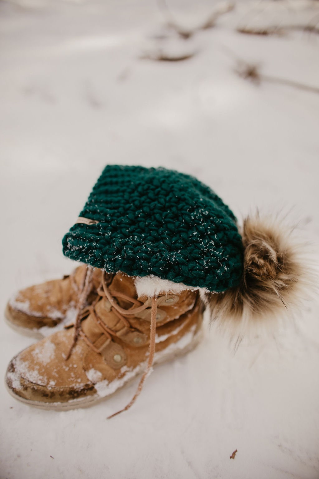 Forest green Peruvian wool knit hat with faux fur pom pom by Woolly Bear Knits, cozy winter accessory featuring warm wool and stylish design.