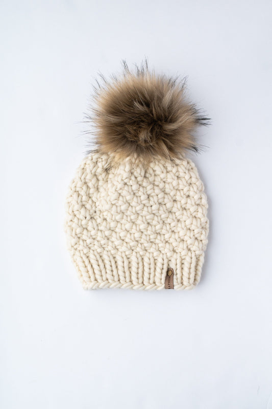 Ivory Peruvian wool knit hat by Woolly Bear Knits with faux fur pom pom, cozy winter accessory with warm wool texture.