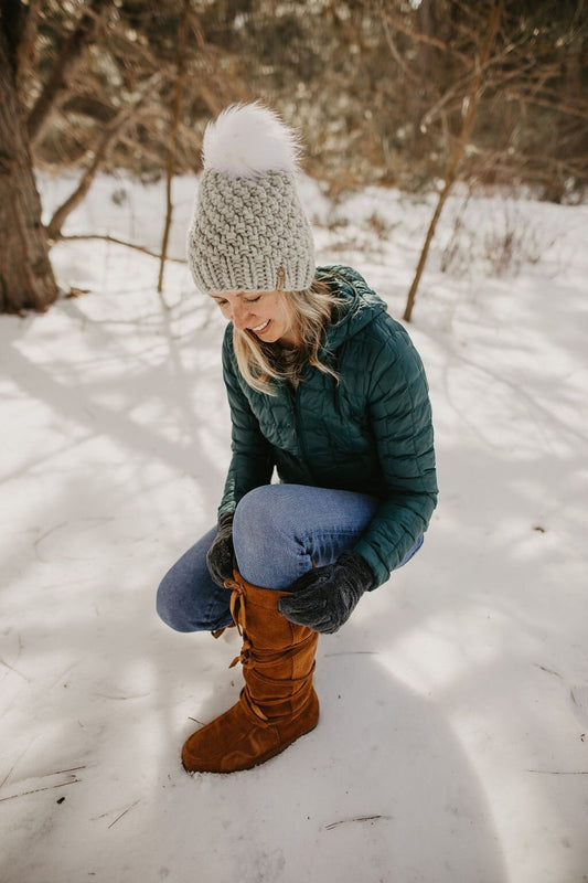 Light gray Peruvian wool knit hat with faux fur pom pom from Woolly Bear Knits, cozy and stylish winter accessory.