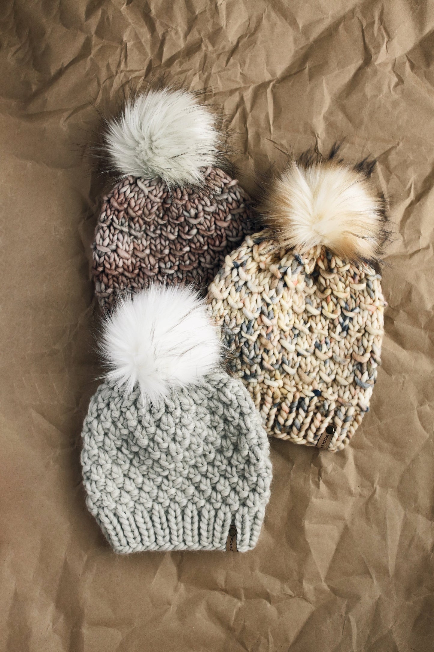 Light gray Peruvian wool knit hat with faux fur pom pom from Woolly Bear Knits, showcasing cozy, warm winter headwear.