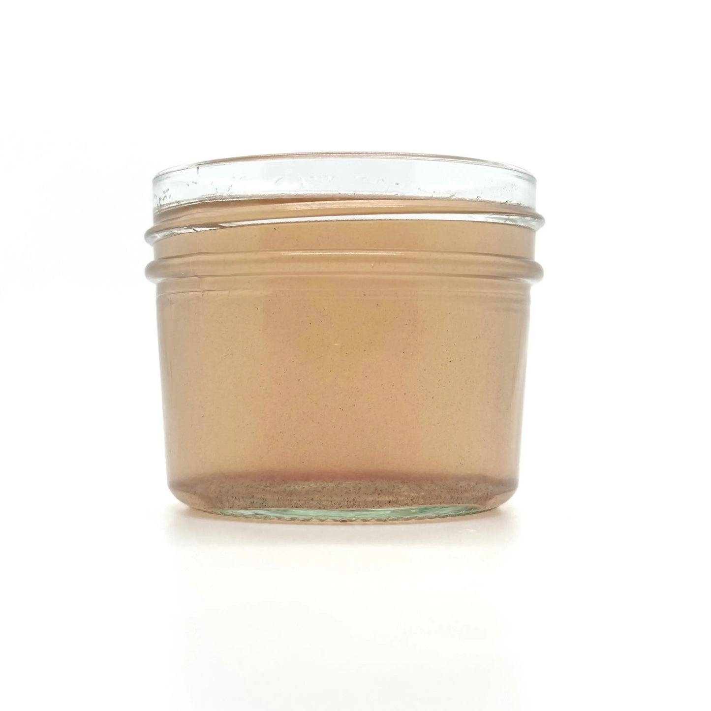Bottle of Your Only Earth Rose Coconut Oil showing the label and clear liquid inside.