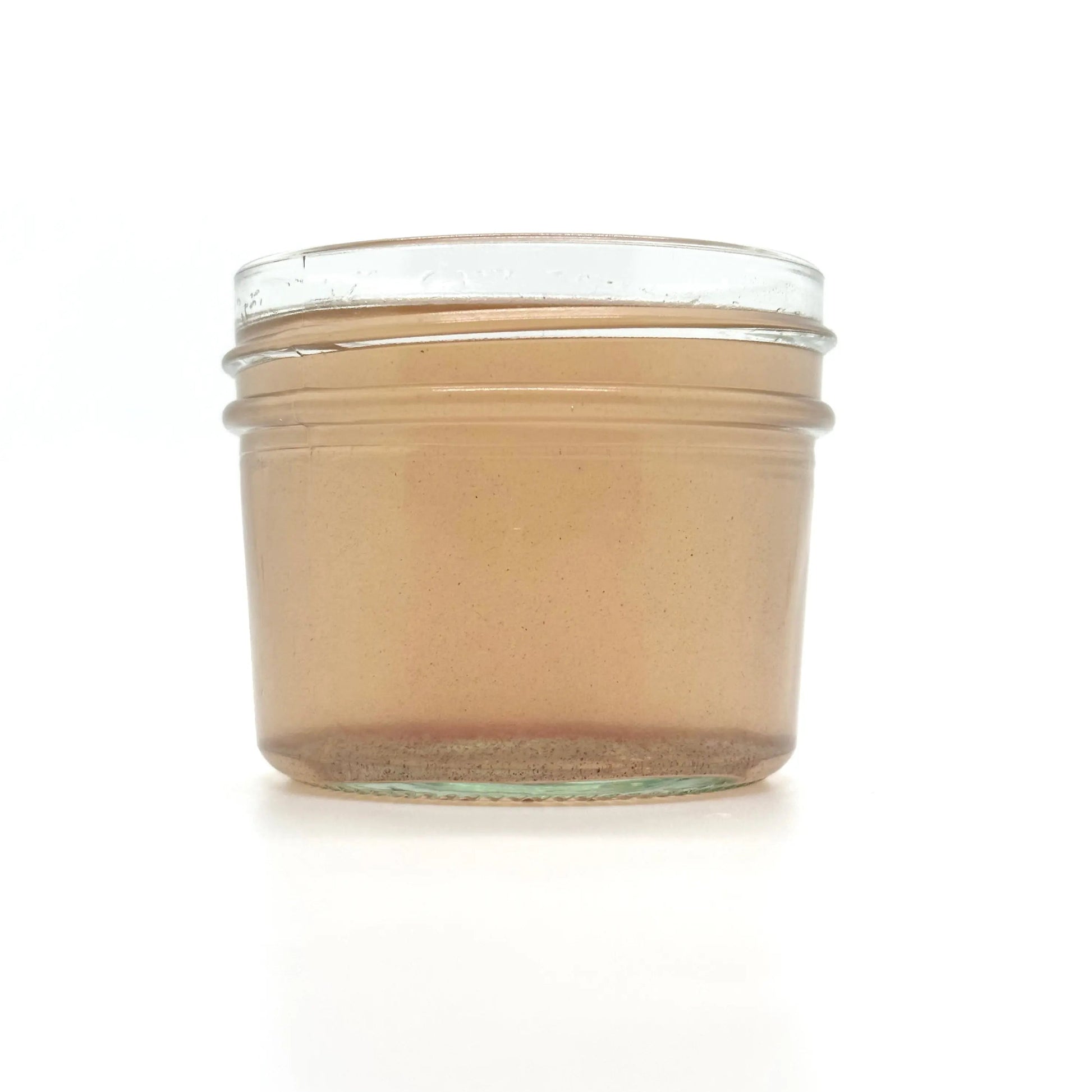 Bottle of Your Only Earth Rose Coconut Oil showing the label and clear liquid inside.