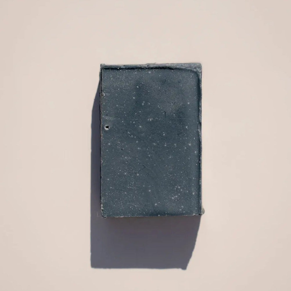 Charcoal soap by Your Only Earth, showing a bar of natural black charcoal soap with textured surface and branding.