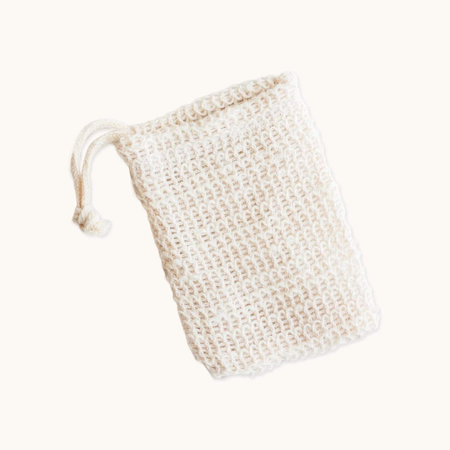 Natural cotton soap saver bag for bath and body use, featuring a drawstring closure and mesh design for gentle exfoliation.