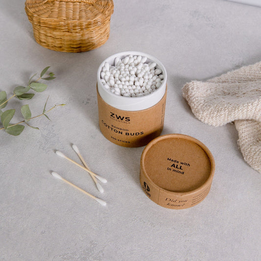 Bamboo cotton buds in a clear container, natural bathroom accessories by ZeroWasteStore.com for eco-friendly personal care.