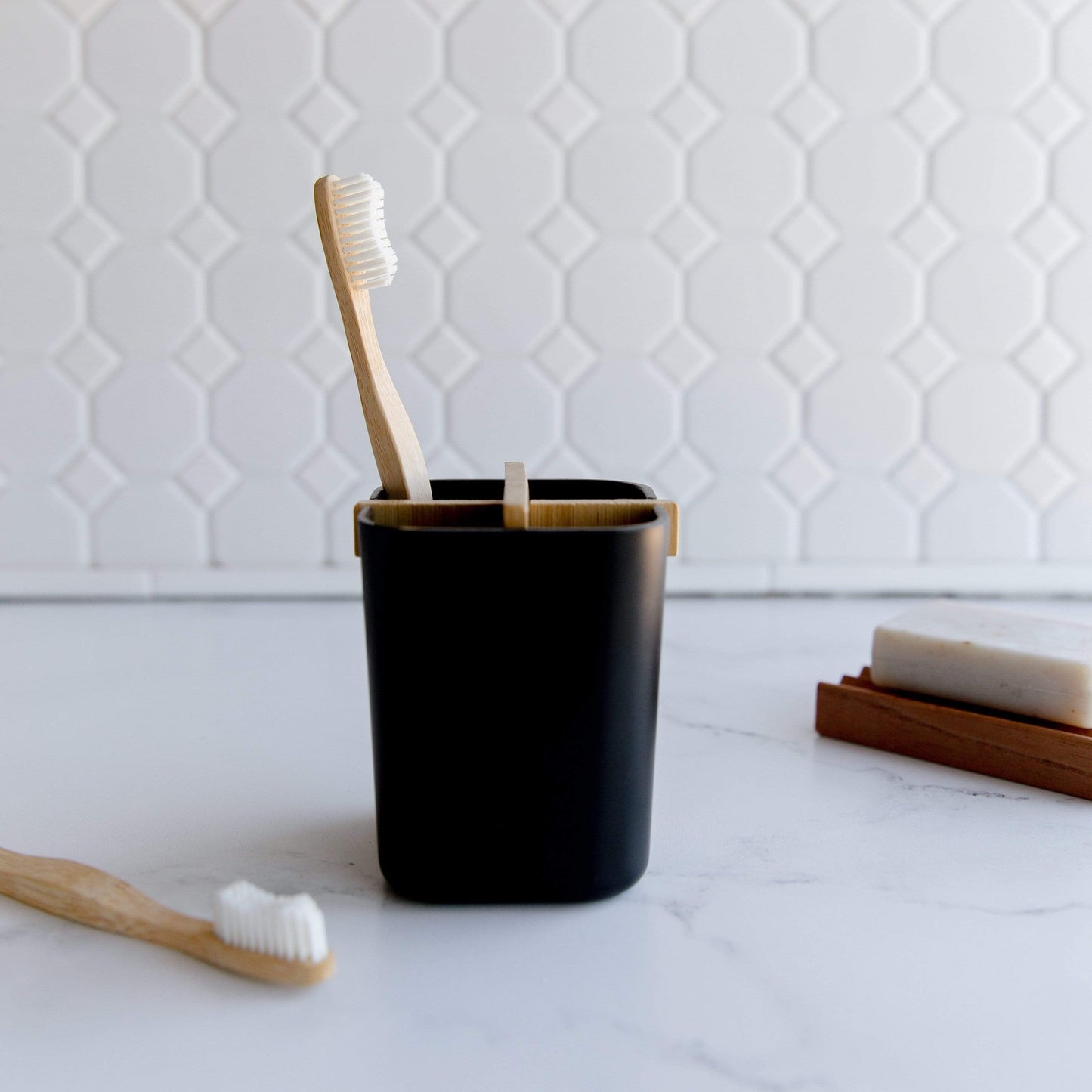 White or black bamboo fiber and corn starch bathroom brush holder from ZeroWasteStore, eco-friendly zero waste bathroom accessory.