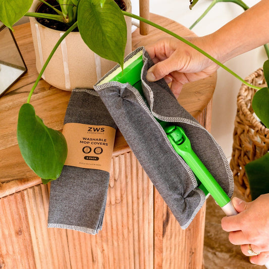 Six white washable mop covers for cleaning tools, designed for eco-friendly, reusable cleaning with ZeroWasteStore.com.