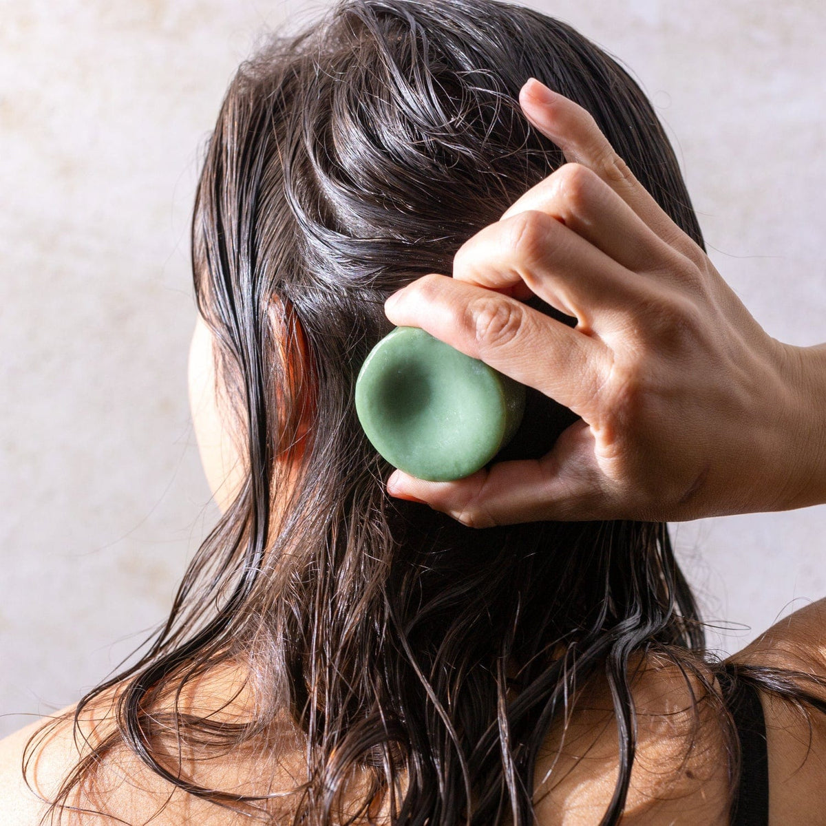 Bloom Castor Oil Conditioner Bar by ZeroWasteStore.com for stronger, softer, healthier hair shown in a natural conditioner bar shape.