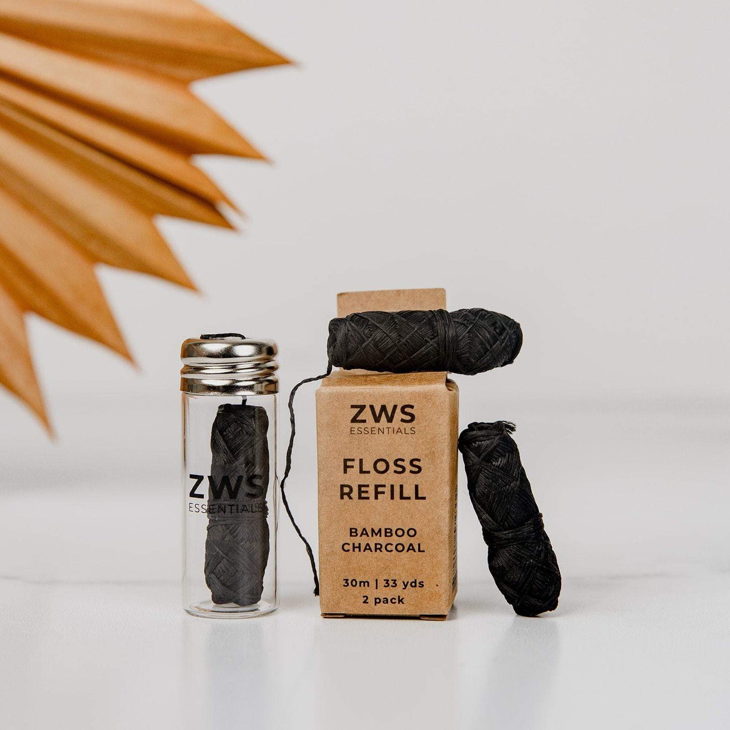 Bamboo charcoal dental floss from ZeroWasteStore.com showing eco-friendly bamboo charcoal-infused dental floss for oral cleaning.