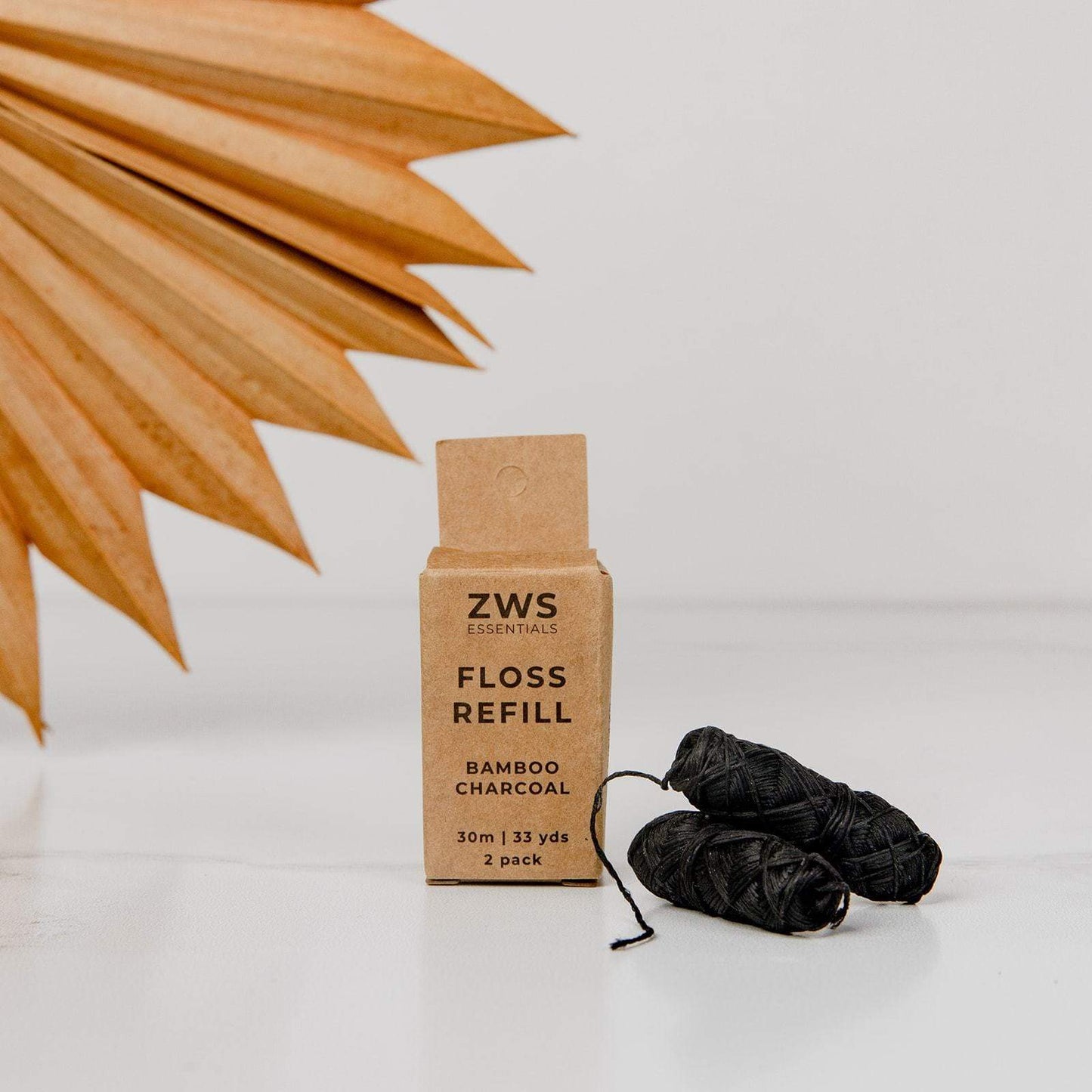 Bamboo charcoal dental floss from ZeroWasteStore.com showing black bamboo charcoal-infused dental floss for oral hygiene.