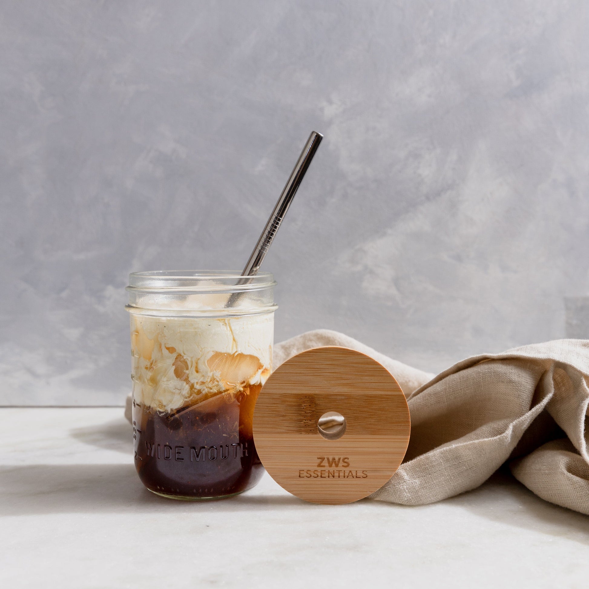 Mason jar drinkware set with bamboo lid and stainless steel straw, perfect for beverages, by ZeroWasteStore.com.