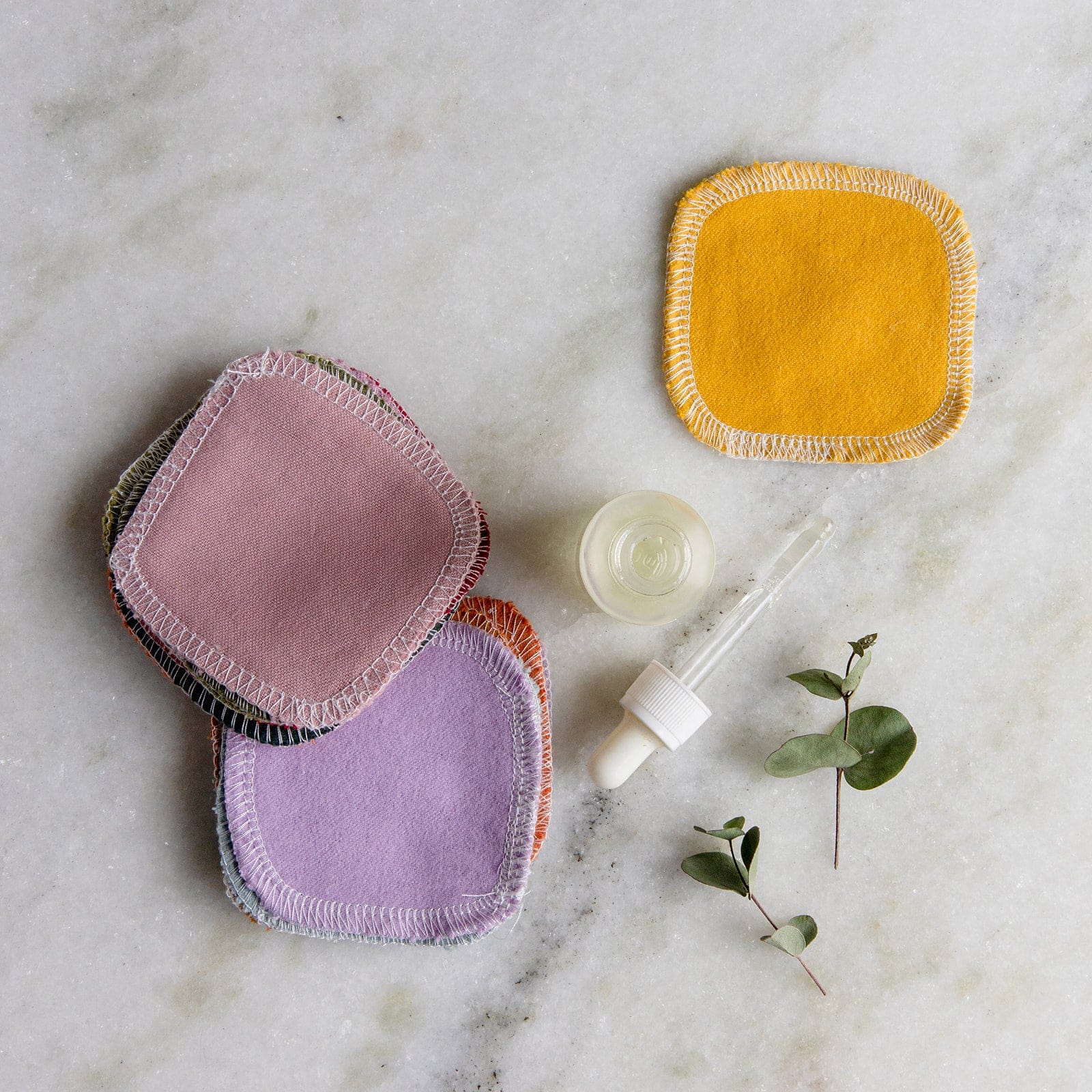 Set of reusable cotton facial rounds in earthy tones from ZeroWasteStore.com, eco-friendly makeup remover pads.