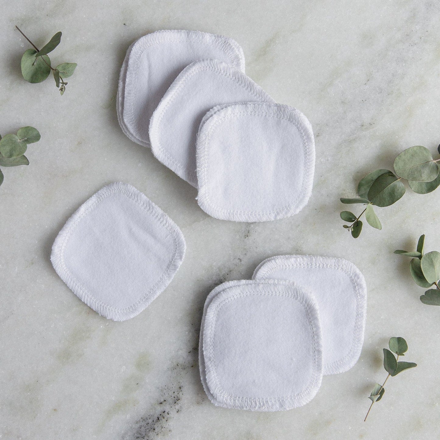 Earth-toned reusable cotton facial rounds from ZeroWasteStore.com, eco-friendly and soft for gentle skincare application.
