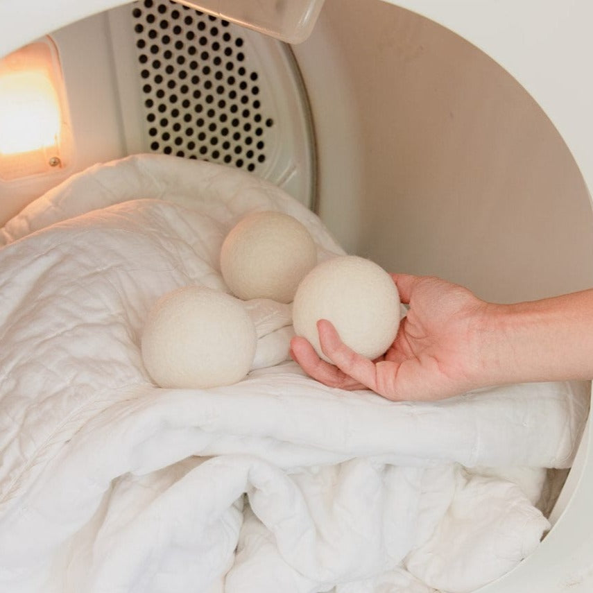 Reusable wool laundry dryer ball from ZeroWasteStore.com, natural felted wool ball for eco-friendly fabric drying.