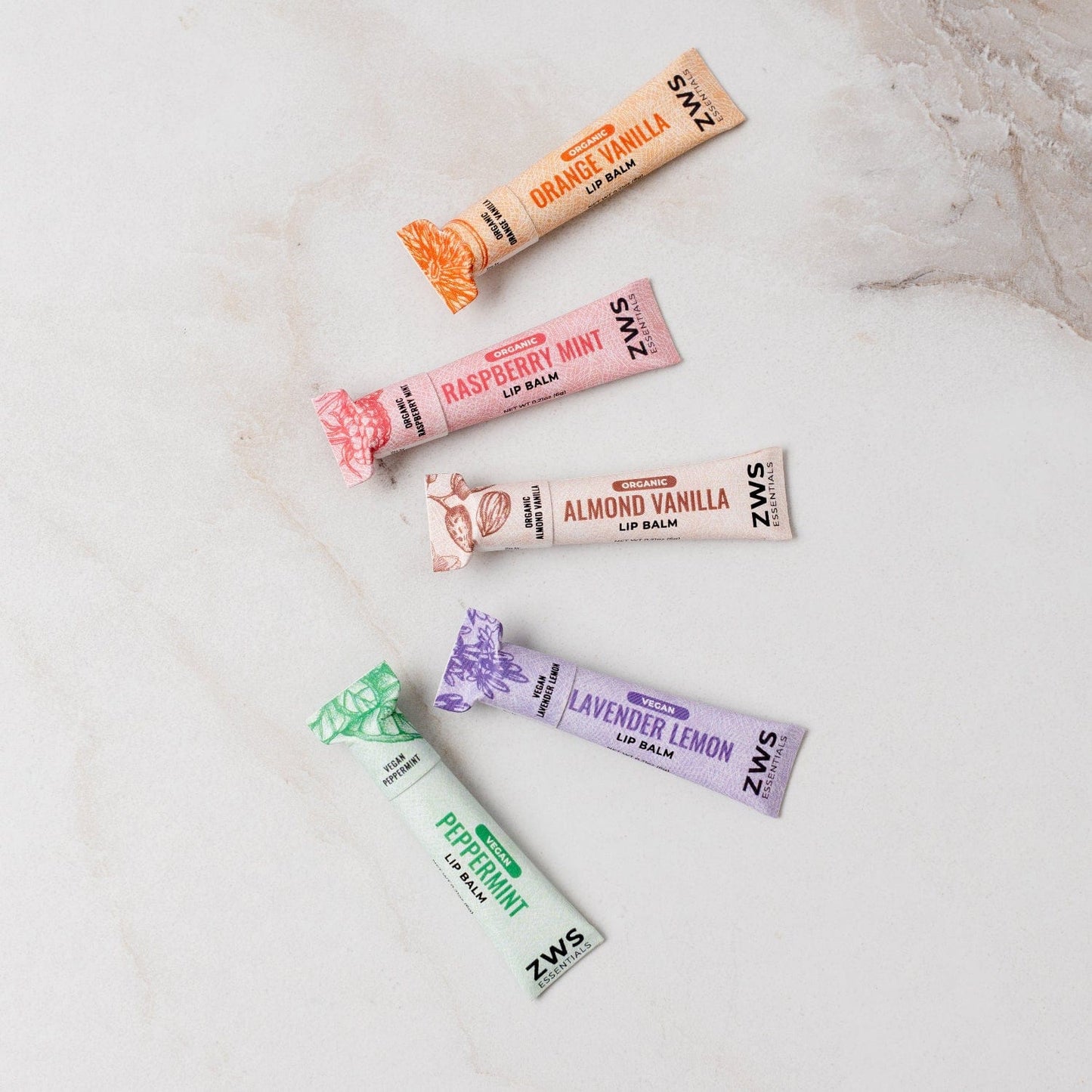 All-natural almond vanilla lip balm in a sleek container, featuring organic ingredients for nourishing and hydrating lips.