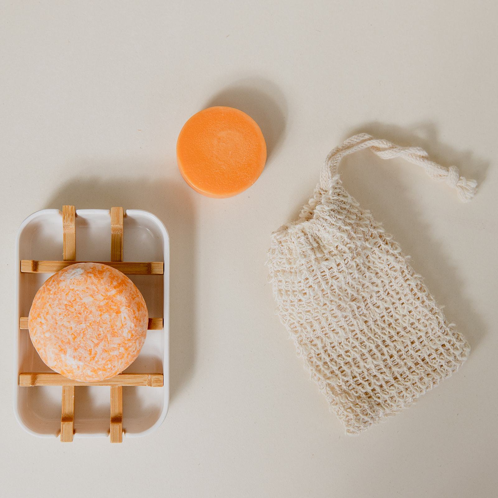 Zero Waste Hair Care Mini Kit with shampoo and conditioner sets, including a white soap dish, eco-friendly packaging.