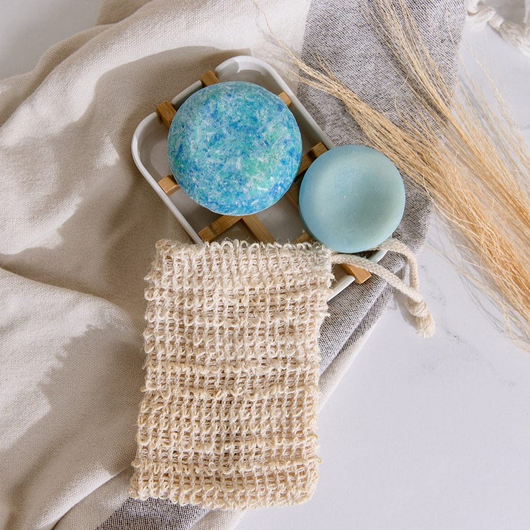Zero Waste Store shampoo and conditioner sets with a white soap dish, part of the eco-friendly hair care mini kit.