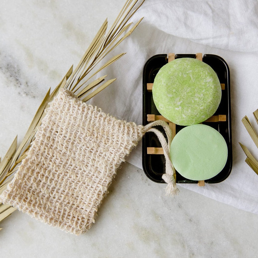 Zero Waste Hair Care Mini Kit with shampoo and conditioner sets, includes a white soap dish, eco-friendly packaging from ZeroWasteStore.com