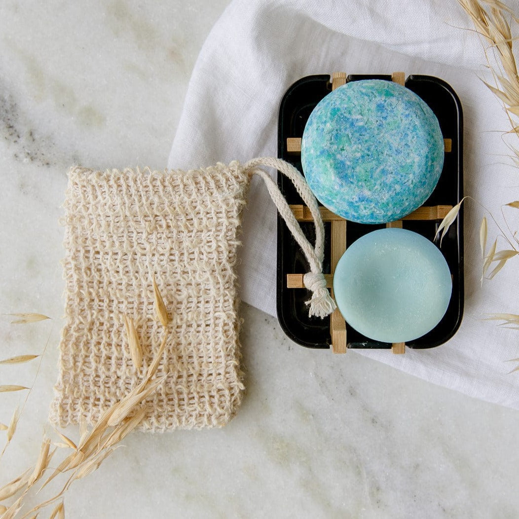 Zero Waste Hair Care Mini Kit with shampoo and conditioner sets and a white soap dish from ZeroWasteStore.com