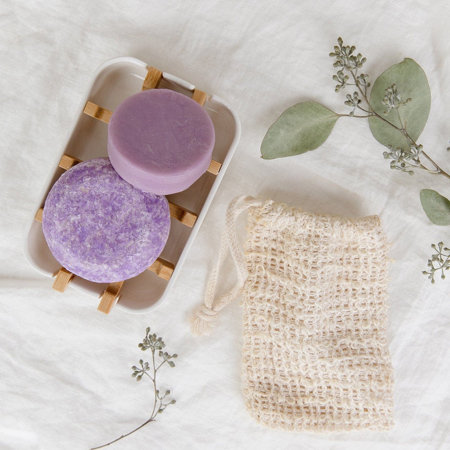 Zero Waste Hair Care Mini Kit by ZeroWasteStore.com with shampoo, conditioner, and a white soap dish for eco-friendly hair care.