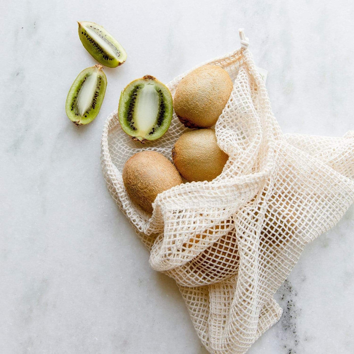 Medium natural mesh produce bag from ZeroWasteStore.com, reusable shopping tote for fresh fruits and vegetables, eco-friendly design.