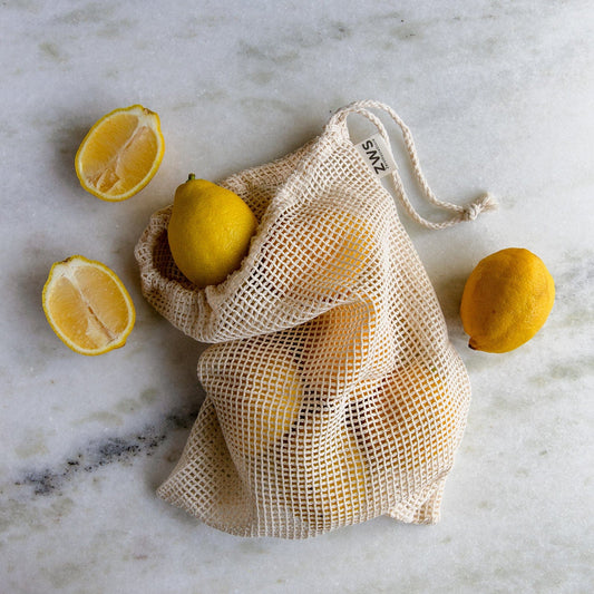 Natural mesh produce bag in multiple sizes, reusable zero waste shopping tote with breathable net material.