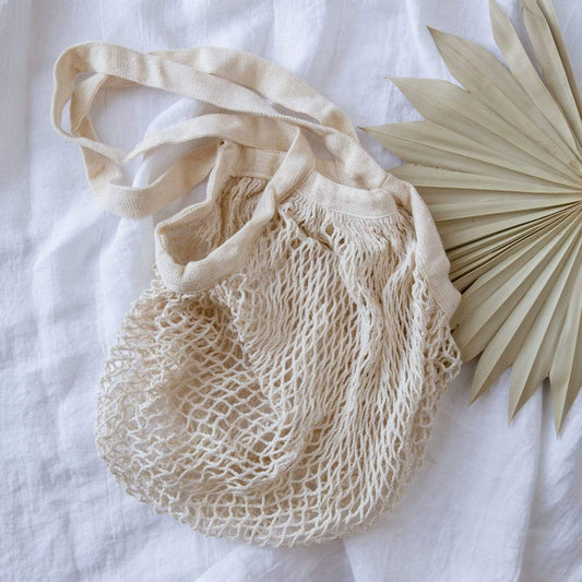 Organic cotton string shopping tote from ZeroWasteStore, eco-friendly mesh market bag, plastic-free and reusable for zero waste shopping.