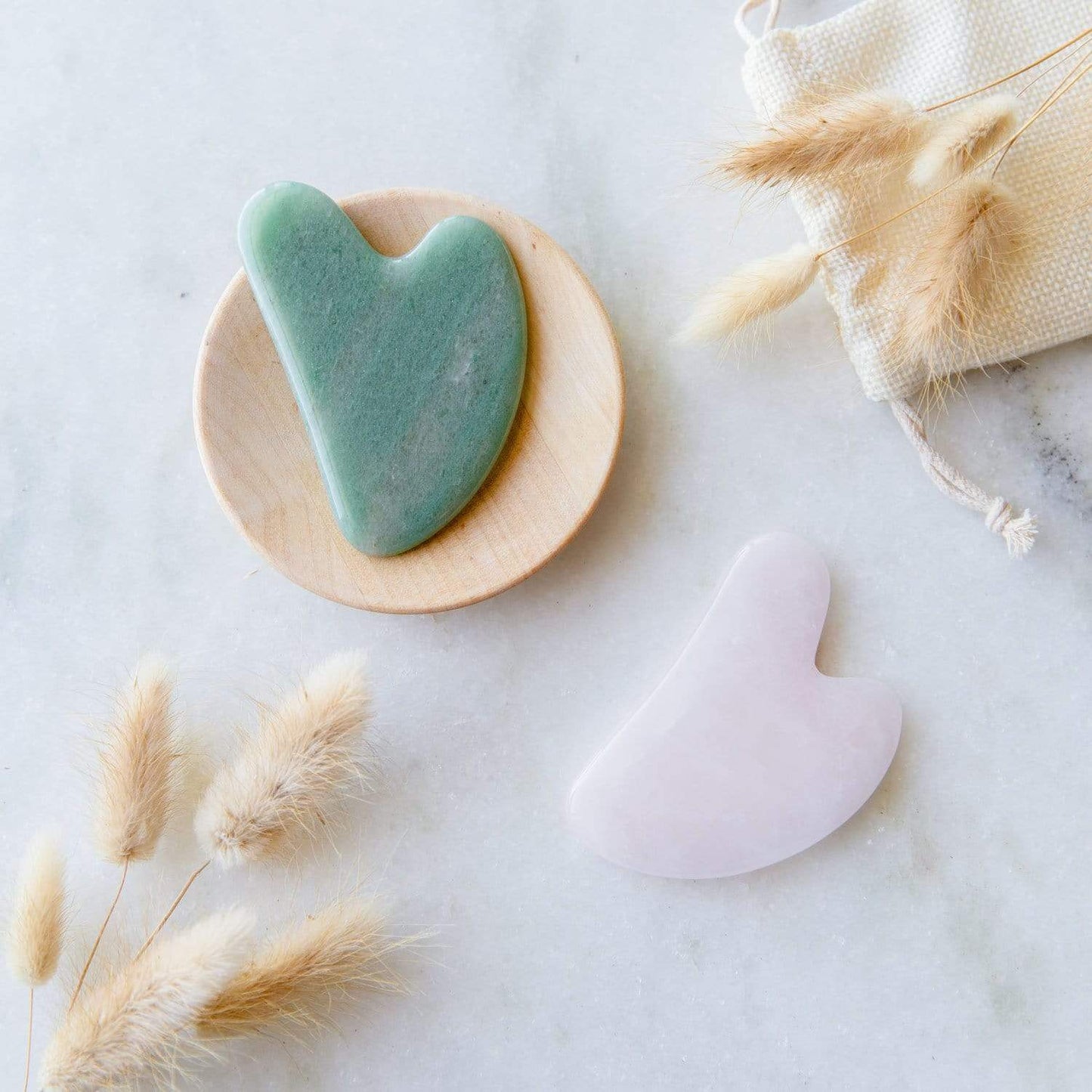 Rose quartz Gua Sha facial tool for skin care by ZeroWasteStore.com, gently designed for facial massage and skin rejuvenation.