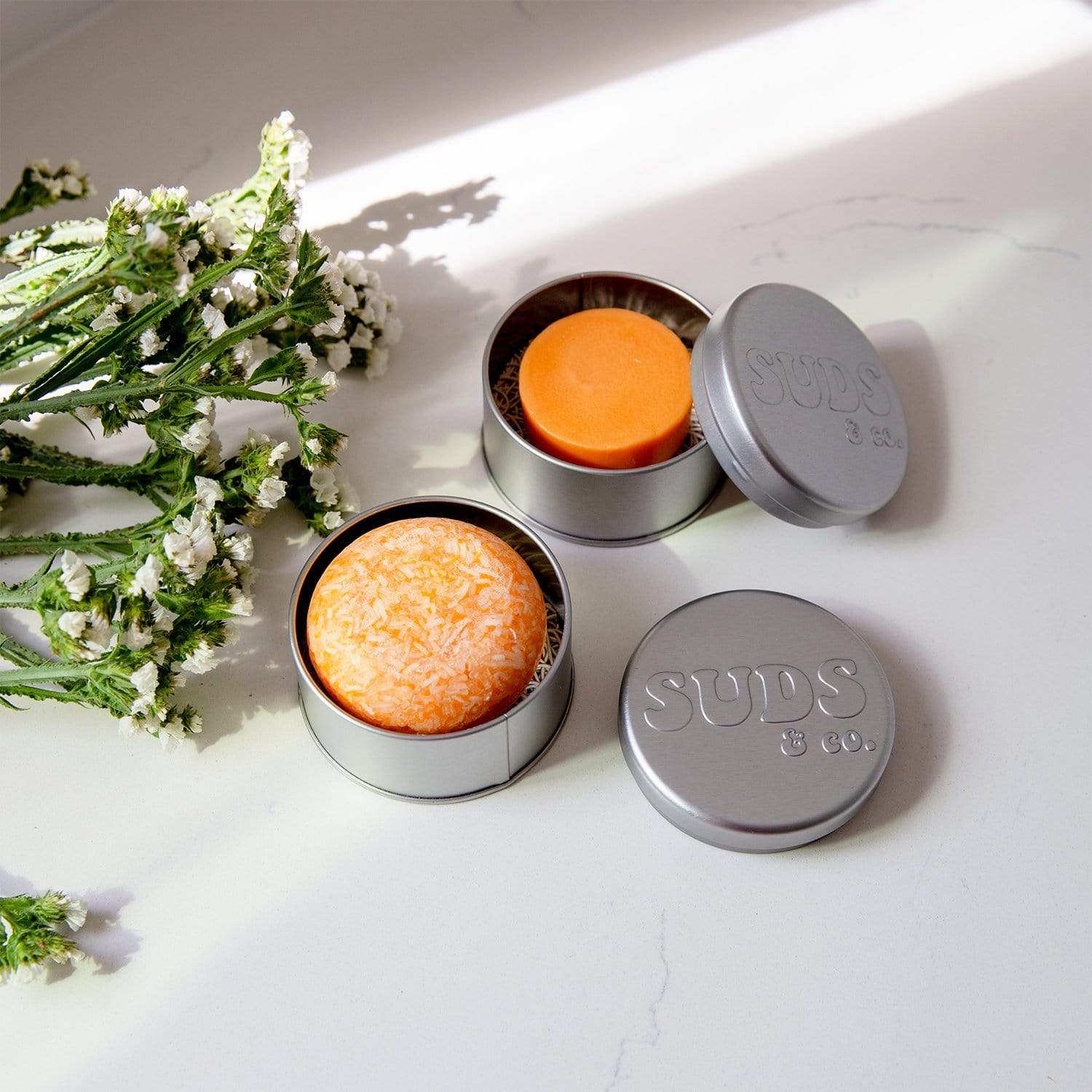 Suds & Co. travel tin for shampoo and conditioner storage, soap dish holder in a compact, eco-friendly container.